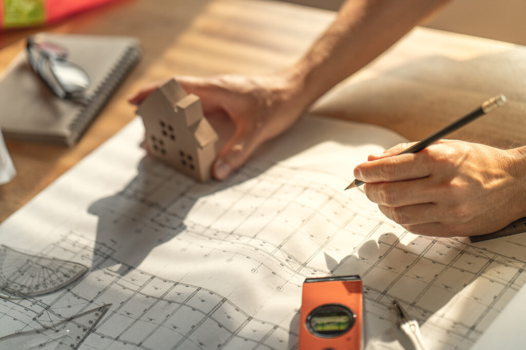 Architect & Engineer working drawing document about project planning and progress of work schedule on the home building construction site