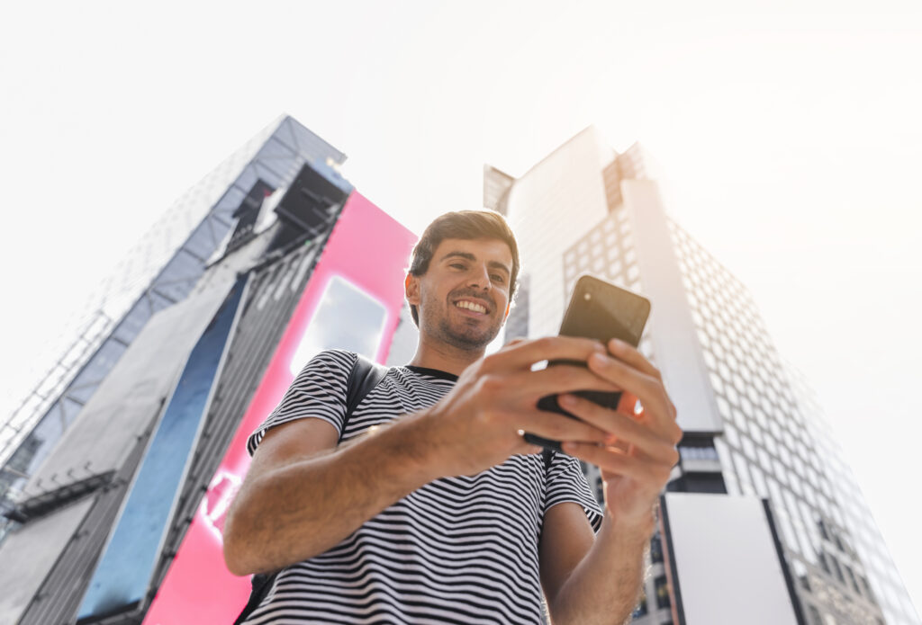young-man-holding-smartphone-with-both-hands