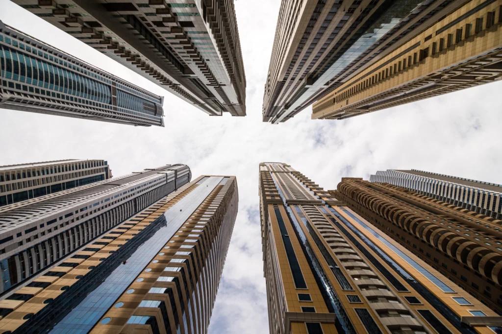 Dramatic perspective with low angle view of skyscrapers looking up to the sky, Dubai. Vanishing point