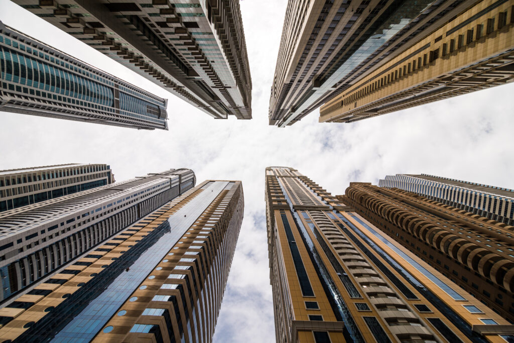 Dramatic perspective with low angle view of skyscrapers looking up to the sky, Dubai. Vanishing point